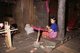 Thailand: Karen woman spinning yarn for weaving, near Mae Sariang, Mae Hong Son Province, northern Thailand